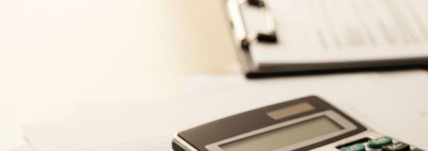 Business loan evaluation process - financial documents and calculator on desk