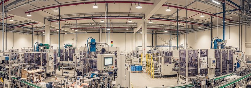 Industrial packaging and labeling equipment production line in a modern manufacturing facility