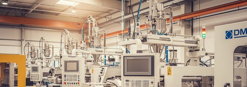 Plastic injection molding machines in a modern manufacturing facility