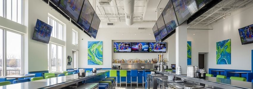 Commercial keg cooler system in a bar setting, showing under-bar refrigeration equipment