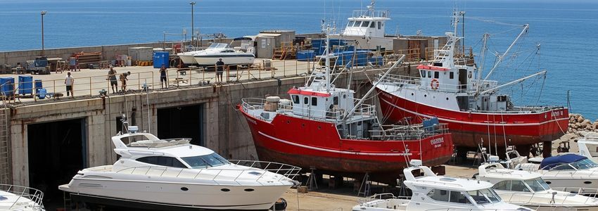 Marine equipment financing options showing commercial vessels at a busy boatyard