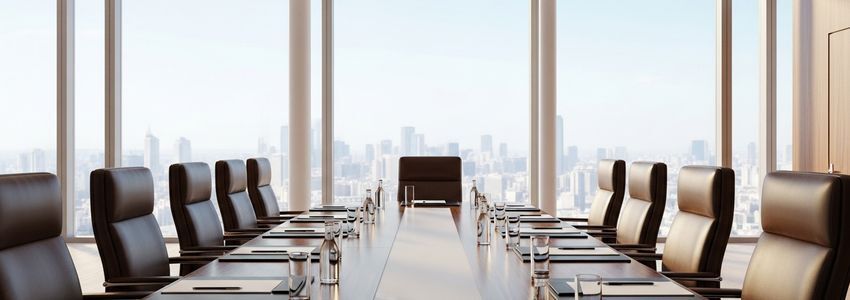 Business owner reviewing investor term sheets and negotiation documents in a modern office