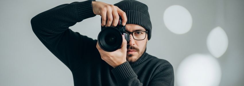 Professional photographer managing their photography business finances with loan documentation