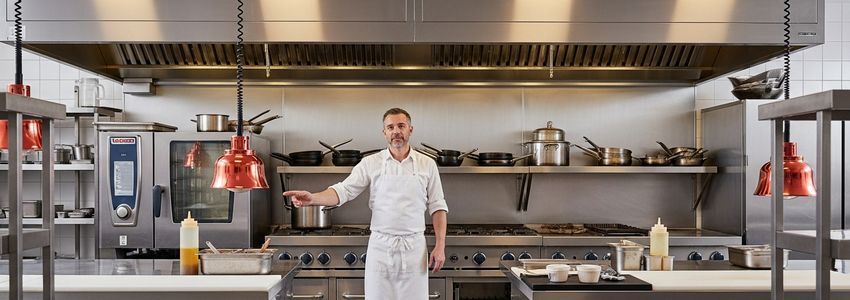 Restaurant owner reviewing equipment financing options with a Crestmont Capital advisor