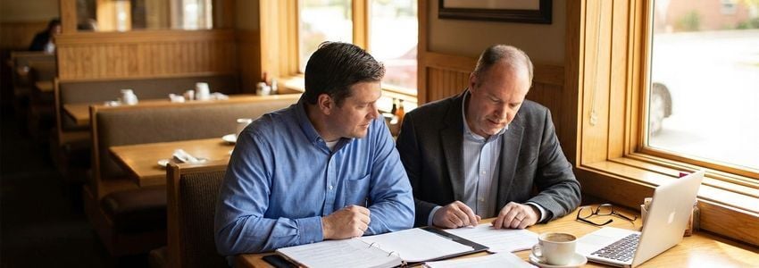 Restaurant owner reviewing financing options with a business consultant