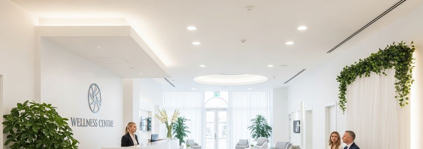 Wellness franchise professional reviewing financing documents at a modern wellness center reception desk