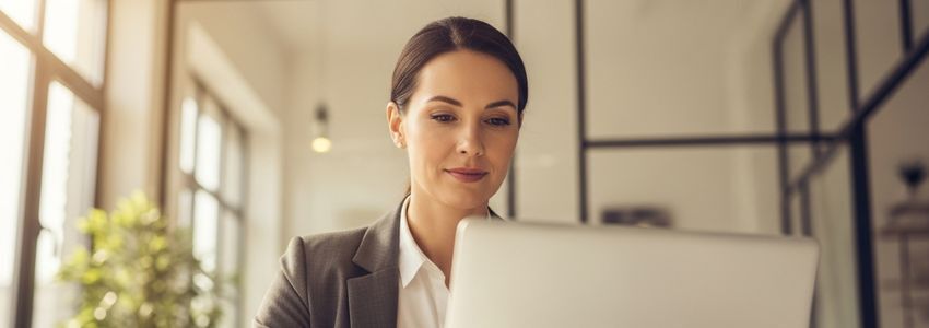 Small business owner applying for a same-day business loan online at a modern office desk
