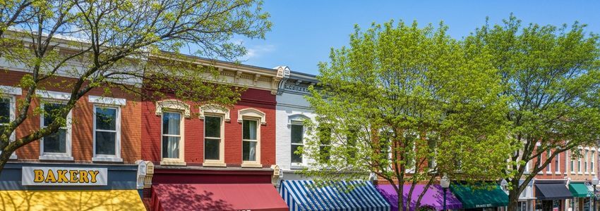 Small business owners reviewing financing options at a Main Street commercial district