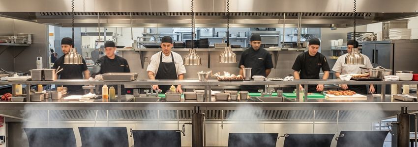 Commercial smoker operation in professional BBQ restaurant kitchen