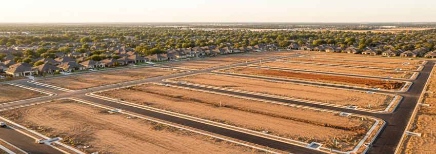 Aerial view of a residential subdivision under active development showing newly graded lots, new roads, and infrastructure installation in a suburban setting