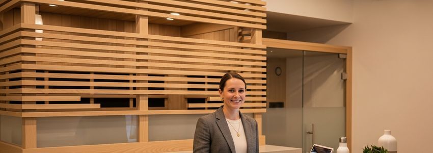 SweatHouz wellness studio reception desk with franchise owner in professional business environment