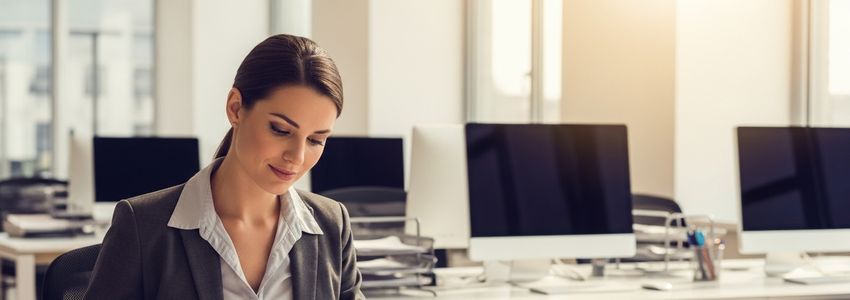 A staffing agency professional reviewing business loan documents in a modern office setting