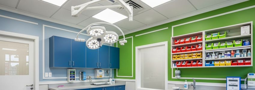 Modern veterinary clinic examination room showing equipment and medical supplies