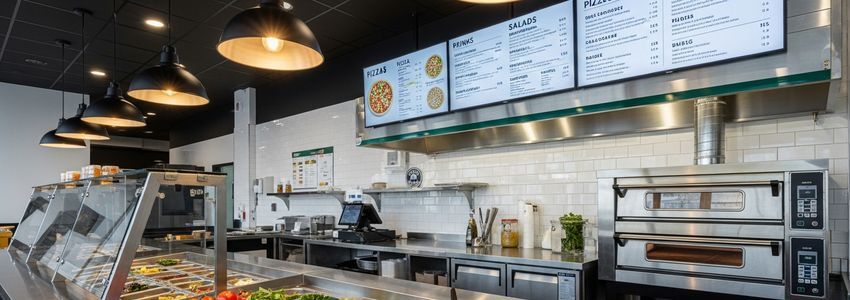 Your Pie franchise restaurant interior showing pizza preparation area and modern fast-casual design