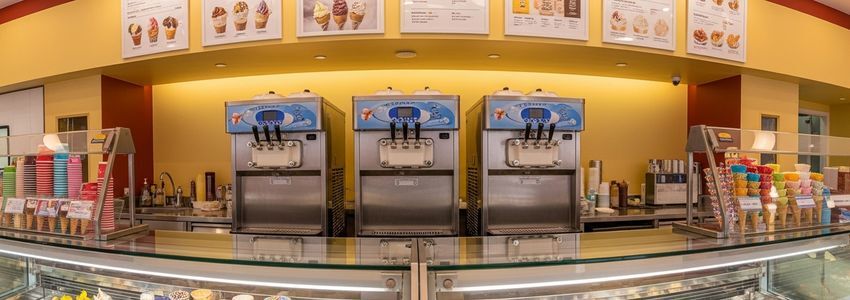 Commercial soft-serve ice cream machines in a modern ice cream shop ready for financing