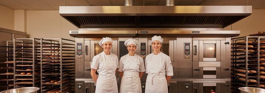 Commercial bakery professionals in a bakery production environment - dough sheeter financing for bakery owners